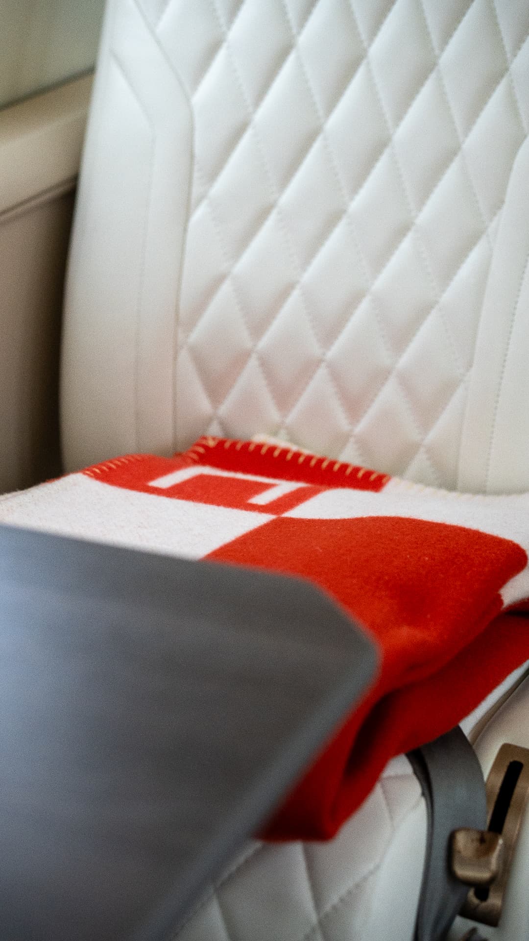 Red blanket detail on the quilted cabin seat